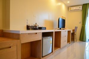 a room with a desk with a television on it at Studio apartments on a hill in Kathu