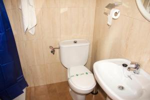 a bathroom with a white toilet and a sink at Camping La Puerta in Moratalla