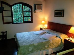 Cama ou camas em um quarto em Pousada Arboretum