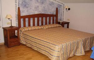 a bedroom with a large bed and two night stands at La Becera in Peñausende