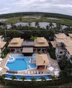 an aerial view of a resort with a swimming pool at Porto das Baleias Praia do Forte in Praia do Forte