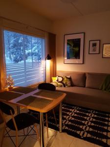 uma sala de estar com um sofá e uma mesa em Ylläs Kanerva 107 em Äkäslompolo