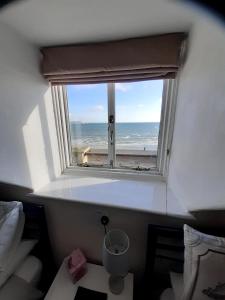 a window in a room with a view of the ocean at The Edenhurst Guesthouse in Weymouth
