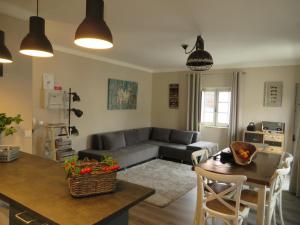 a living room with a couch and a table at SEA URCHIN MILFONTES by Stay in Alentejo in Vila Nova de Milfontes