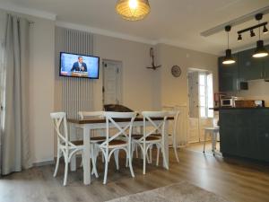 a kitchen and dining room with a table and chairs at SEA URCHIN MILFONTES by Stay in Alentejo in Vila Nova de Milfontes