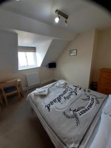 a bedroom with a bed with a sign on it at The Edenhurst Guesthouse in Weymouth