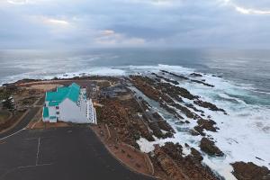 an aerial view of a beach with the ocean at The Point Hotel & Spa in Mossel Bay