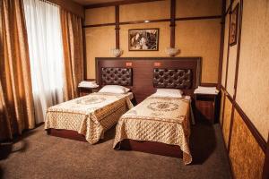 a hotel room with two beds in a room at Stariy Rostov Hotel in Rostov on Don