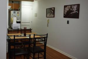 a kitchen with a table and chairs and a refrigerator at Dpto 1D 1B, Metro Bellas Artes, equipado full con WiFi in Santiago