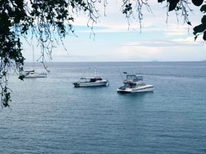 three boats floating on a large body of water at Solomon Kitano Mendana Hotel in Honiara