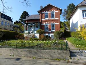 a brick house with a fence in front of it at Villa Kaethe Borby in Eckernförde