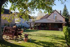 a yard with a bench in front of a house at Apartmani Bojana in Vrdnik