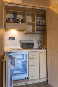 a small kitchen with a sink and a refrigerator at Affittacamere La Ferrata in San Michele allʼAdige