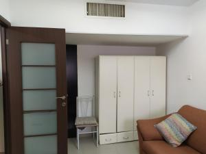 a living room with a couch and a chair at Nelly's Housing Unit in Eilat