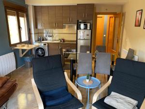 a kitchen and living room with chairs and a table at Apartamento Turístico Snow Boutique in Camarena de la Sierra