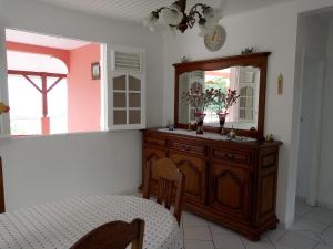 uma sala de jantar com um espelho e uma mesa em VILLA C'MARGOT em Marigot