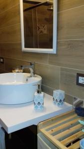 a bathroom with a sink and a mirror at casa Trieste in Scoglitti