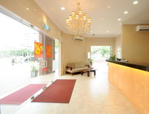 eine Lobby mit einer Rezeption und einem Kronleuchter in der Unterkunft Celyn City Hotel in Kota Kinabalu