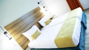 Postel nebo postele na pokoji v ubytování Hamilton Suites & Appart