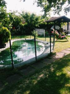 a fence around a swimming pool in a yard at Seaside Cottage in Paralia Katerinis