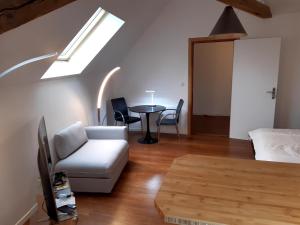 a living room with a couch and a table at loft studio avec charme et authenticité in Altkirch
