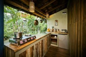 a kitchen with a counter with a stove in it at Casa Vana Hiriketiya in Hiriketiya