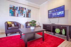 TV at/o entertainment center sa Santiago Rent Apart