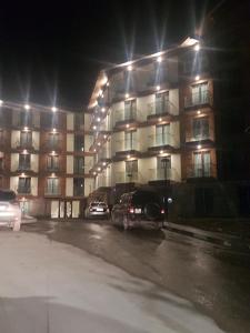 a parking lot in front of a building at night at New Gudauri Loft 2 - "Mano", near ski lift Gondola in Gudauri