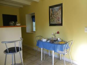 a table with a blue table cloth on it in a room at La Petite Varenne in Turny
