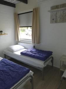 En eller flere senge i et værelse på Rustige, gelijkvloerse vakantiewoning met 2 slaapkamers in Simpelveld, Zuid-Limburg