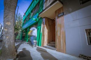 a person walking down a sidewalk in front of a store at Santiago Rent Apart in Santiago