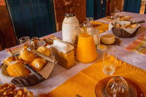 a table with bread and a jug of orange juice at Hospedaria Vó Zazá in Carrancas