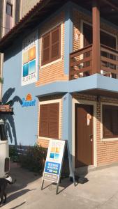 a building with a sign in front of it at Beach House Floripa - Sunset in Florianópolis