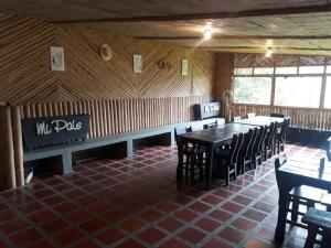 a dining room with tables and chairs in a restaurant at Mirador Las Marcadas in Santa Rosa de Cabal