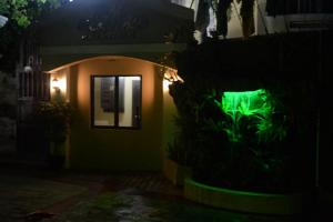 アンヘレスにあるDM レジデンテ ヴィラズの夜の庭に水槽がある家