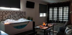a living room with a large tub in the middle of a room at El nido de la Galería in Setenil