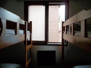 
a bedroom with a bunk bed and a window at Duri Guest House in Seoul
