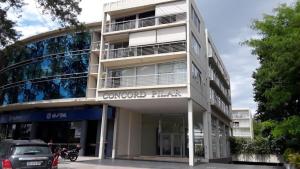 a building with a car parked in front of it at Concord Pilar Suite Almendros in Pilar