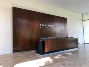 a lobby with a wood paneled wall in a building at Concord Pilar Suite Almendros in Pilar