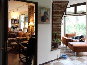 a living room with a brick wall at Hotel Wellies in Karuizawa