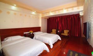 En eller flere senge i et værelse på Guangzhou Junshan Hotel - Shuttle bus for Canton Fair