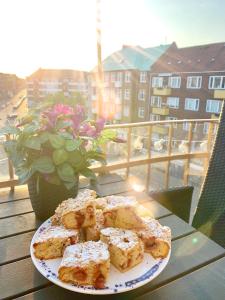 a plate of food on a table on a balcony at Four Individual Beautiful Spacious Rooms In Stylish Apartment in Copenhagen