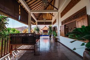 an open lobby with a view of a house at Villa Bukit Malas 3 in Amed