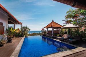 a swimming pool in a villa with a view of the ocean at Villa Bukit Malas 3 in Amed