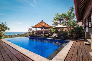 a swimming pool with a gazebo next to a house at Villa Bukit Malas 3 in Amed +14 photos