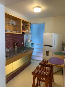 a kitchen with a refrigerator and a table and chairs at Departamentos Pánuco in Mexico City