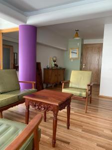 a living room with a table and two chairs at Departamentos Pánuco in Mexico City