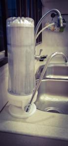 a container of paper towels sitting next to a sink at The Floral Home in Melaka