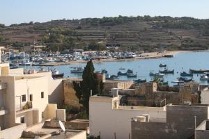 a view of a harbor with boats in the water at Harbour Lodge in Marsaxlokk