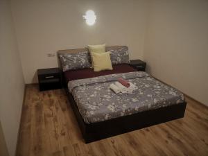a bedroom with a bed with two stuffed animals on it at Kalniečiai park apartment in Kaunas